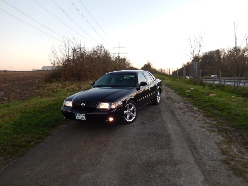 Black 2003 Mercury Marauder parked on a dirt road, facing forward.