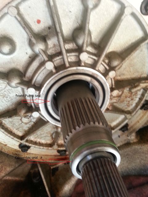 1994 Ford Bronco - Annotated photograph of a transmission shaft pointing out seal locations, not a diagram.