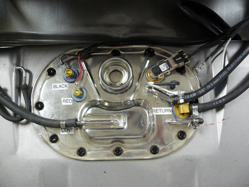 Fuel pump sending unit with labels BLACK, RED, VENT, RETURN, and fuel lines.