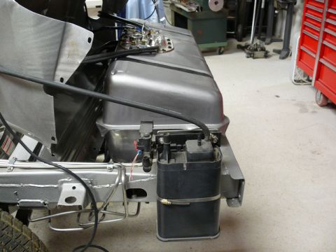 Custom fuel tank and charcoal canister assembly mounted on a vehicle frame.