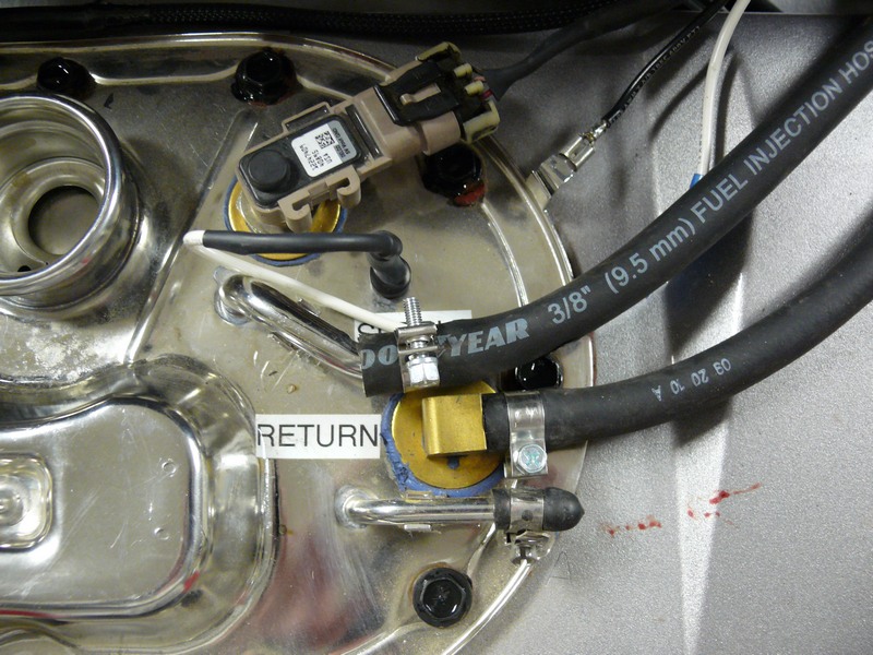 Fuel pump assembly with "RETURN" label, Goodyear fuel injection hoses, and sensor.