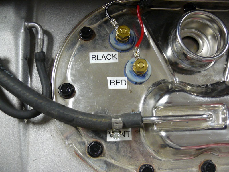 Fuel pump assembly with black and red wire connections and a vent hose.