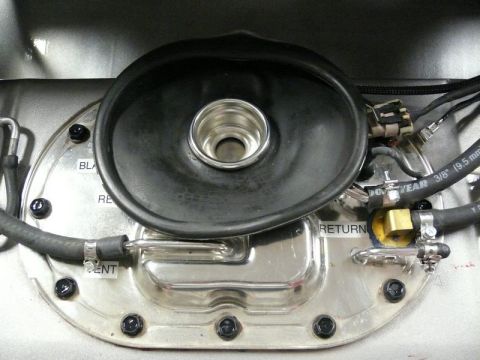 Fuel pump assembly with black rubber diaphragm, metal fittings, and hoses.