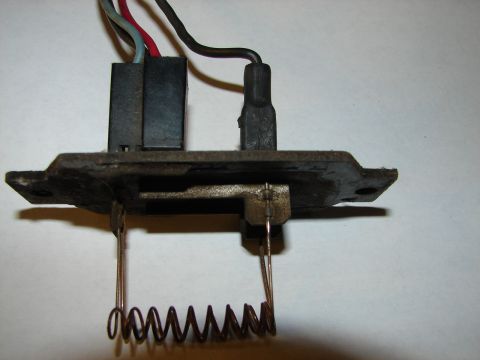 1973 Ford Ranchero - A close-up view of a vehicle's blower motor resistor with wires and a coiled resistor element.