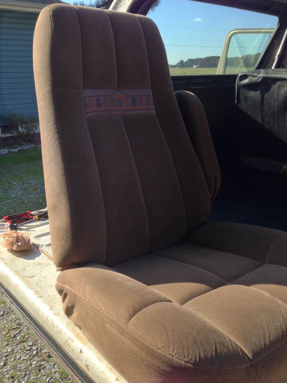 Brown fabric car seat with tree pattern detail