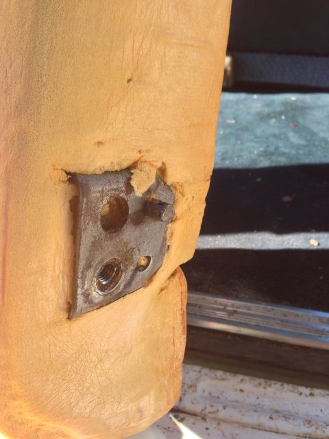 1979 Ford Bronco - Close-up of damaged seat foam revealing an exposed metal mounting bracket.