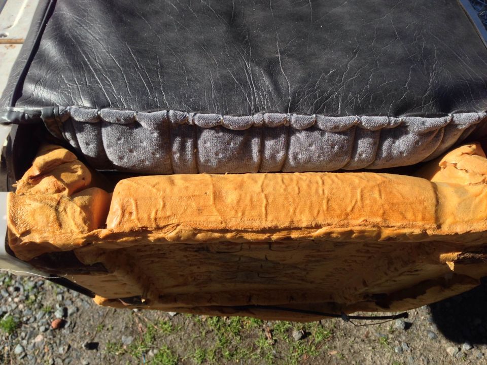 Car seat cushion with black vinyl and orange foam