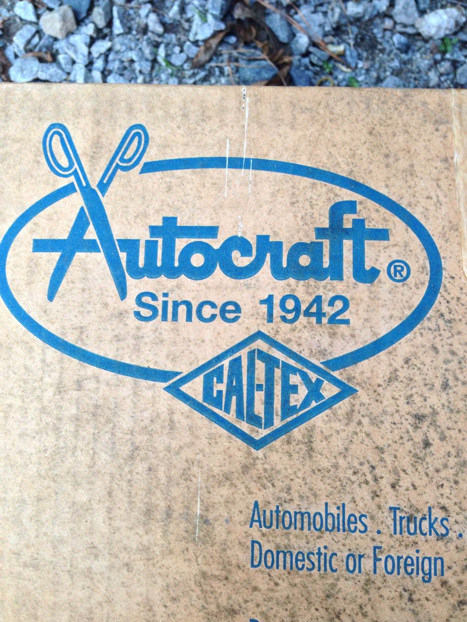 Cardboard box with Autocraft and Caltex logos