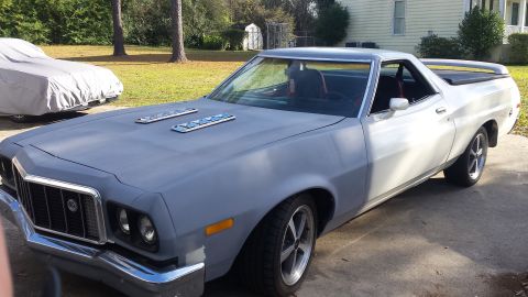 1976 Ford Ranchero - A light-colored 1976 Ford Ranchero is parked outdoors in front of a house. The vehicle is shown from a 3/4 front angle, with its hood paint…