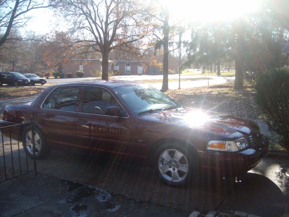 2004 Ford Crown Victoria sedan, dark red, parked on driveway, sun glare