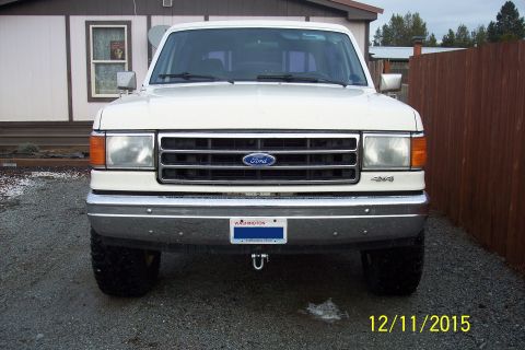 1990 Ford Bronco - Front view of a 1990 Ford Bronco, showing the grille and headlights.