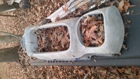 1970 Pontiac Firebird - A car grille, likely from an older model, is covered in fallen leaves and debris.