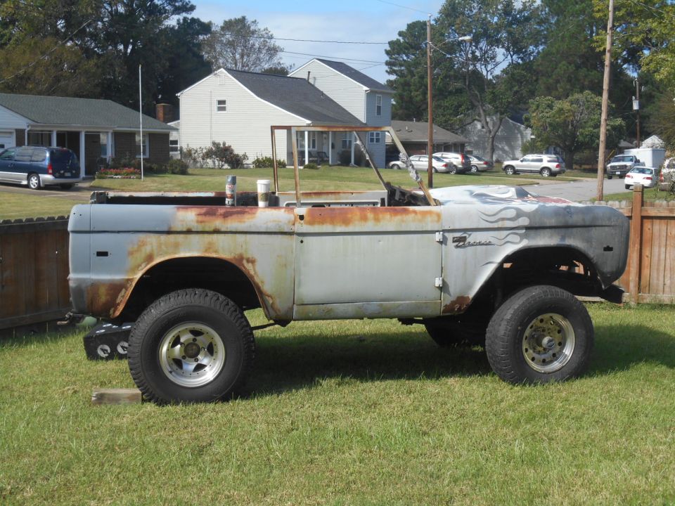 1972 Ford Bronco body, rusty and missing parts, parked on grass