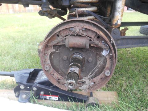 1972 Ford Bronco - Close-up of a vehicle's rear axle brake drum assembly, with the drum removed for service.