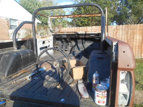 1972 Ford Bronco - This vehicle appears to be undergoing restoration, with its interior and bed exposed and parts laid out.