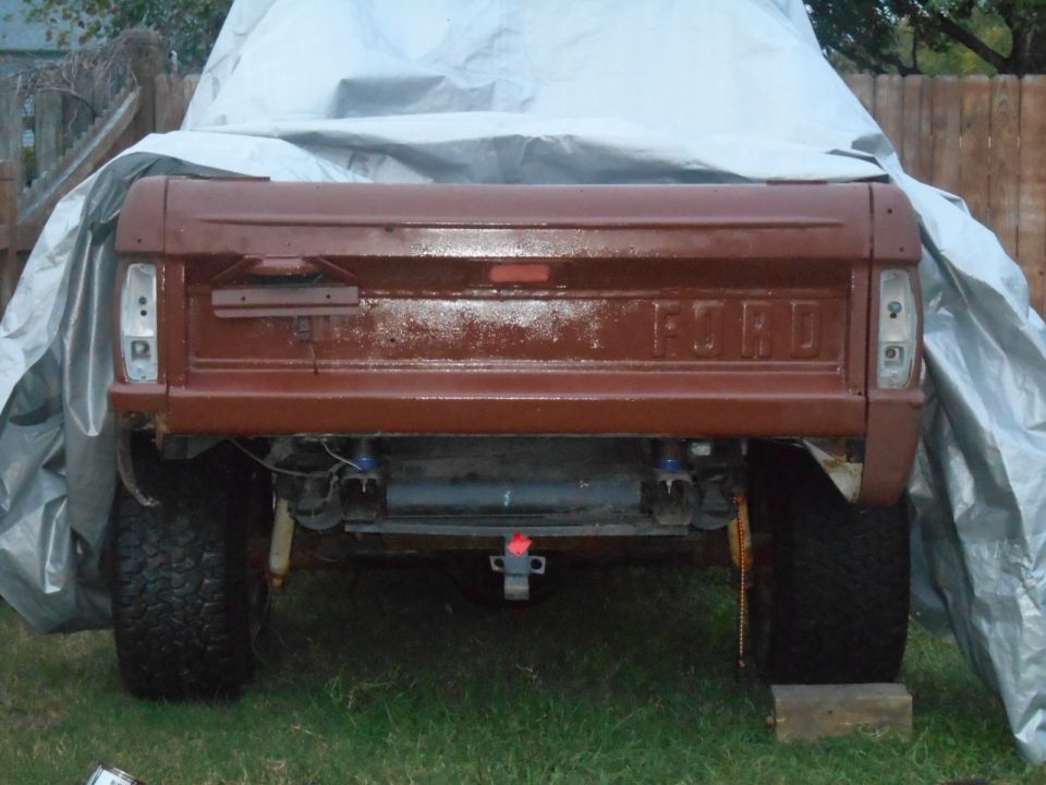 1972 Ford Bronco rear view, tailgate painted brown, partially covered