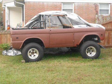 1972 Ford Bronco - This 1972 Ford Bronco is in primer and partially covered, sitting in a yard.