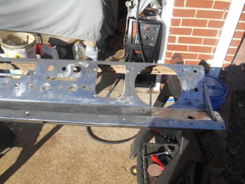 1972 Ford Bronco - A bare metal dashboard frame, likely for a classic vehicle, is shown outdoors with tools and a welding machine nearby.