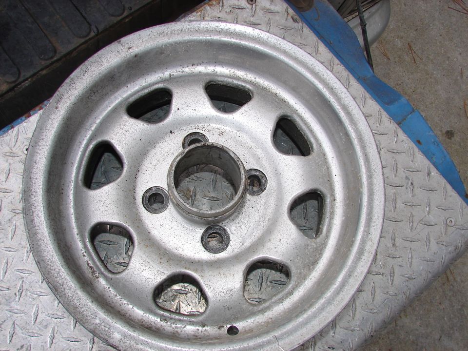 Silver wheel with oval cutouts and a central hub