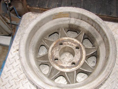 1973 Ford Ranchero - This is a close-up of a single, weathered alloy wheel, likely a spare part.
