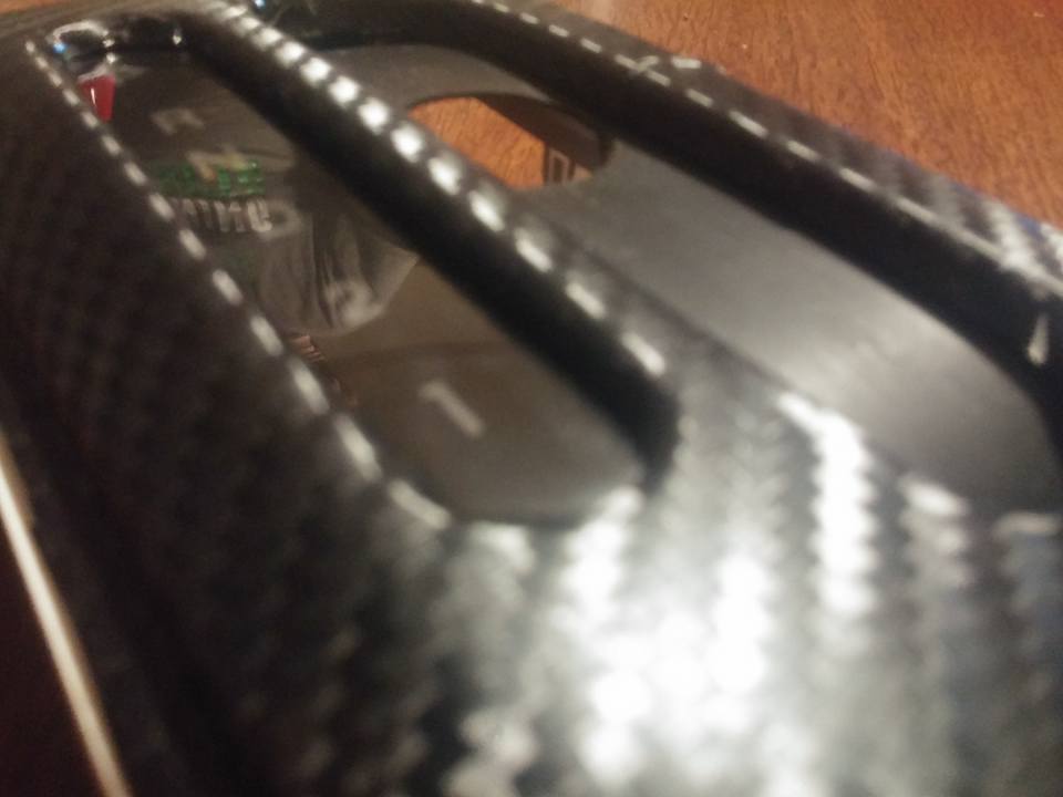 Carbon fiber trim on a vehicle's interior gear shifter console with a visible '1' indicator