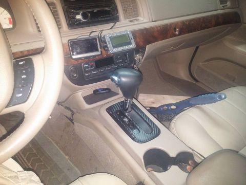 2000 Mercury Grand Marquis - Interior view of a 2000 Mercury Grand Marquis, aftermarket GPS units and wood trim.