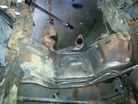 1994 Ford Bronco - Underside view of vehicle frame components, including exhaust system parts.