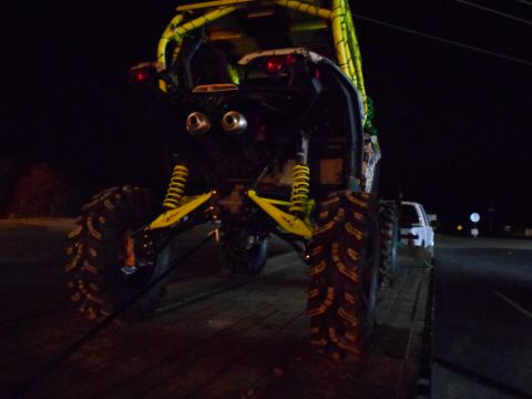1992 Ford Bronco - An off-road buggy is loaded onto a trailer at night, with a white pickup truck in the background.