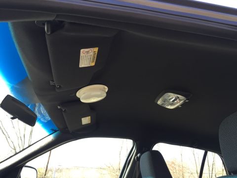 2001 Ford Crown Victoria - Interior view of car ceiling showing sun visors and lights.