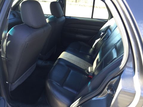 2001 Ford Crown Victoria - Rear interior view of a 2001 Ford Crown Victoria, showing the back seats and door panel.
