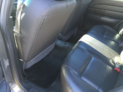 2001 Ford Crown Victoria - The interior of a vehicle shows the rear seats and floor mats.