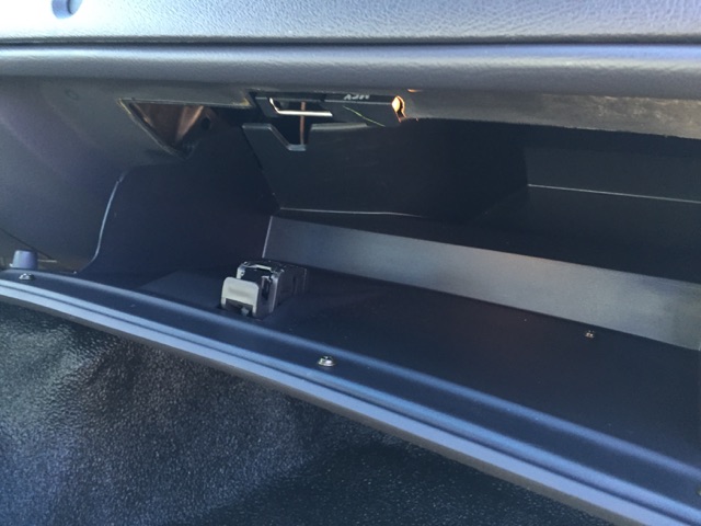 Open glove compartment with a watch inside