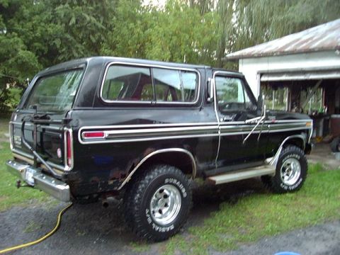 1978 Ford Bronco - This 1978 Ford Bronco is parked outside a garage with trees in the background.