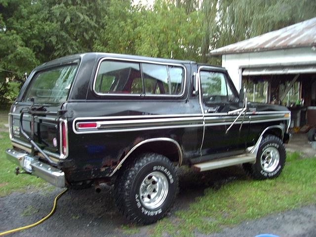 1978 Ford Bronco parked in front of a garage, rear quarter view
