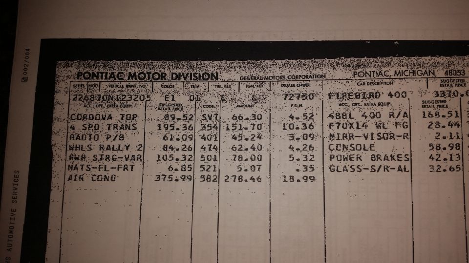 Close-up of a Pontiac vehicle price list document.