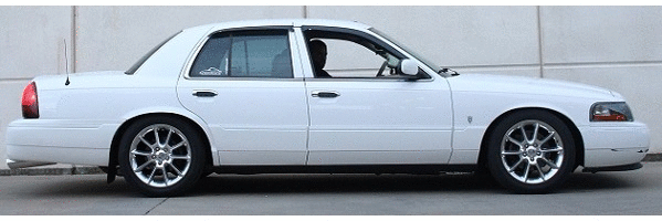 Side-profile photo of a white Mercury Grand Marquis sedan