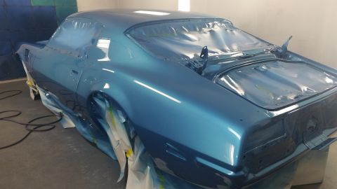 2015 Chevrolet new - A classic blue coupe, likely undergoing restoration, is shown from a rear three-quarter angle in a paint booth. The vehicle is covered in p…