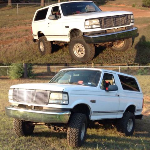 1996 Ford Bronco - This is a two-image split of a white, two-door Ford Bronco. The top image shows the front 3/4 view of the vehicle parked on a grassy inclin…
