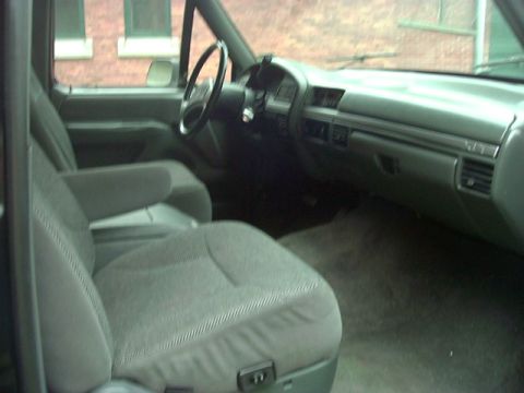 1992 Ford Bronco - The interior of a truck shows the passenger seat, dashboard, and steering wheel.