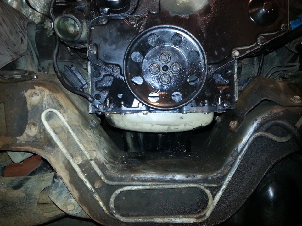 Underside of a 1994 Ford Bronco showing engine, oil pan, and frame
