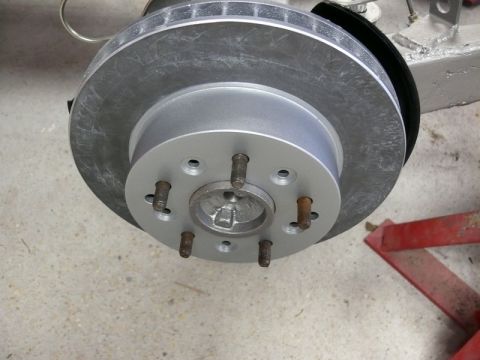 Vehicle brake rotor and hub assembly with lug studs.