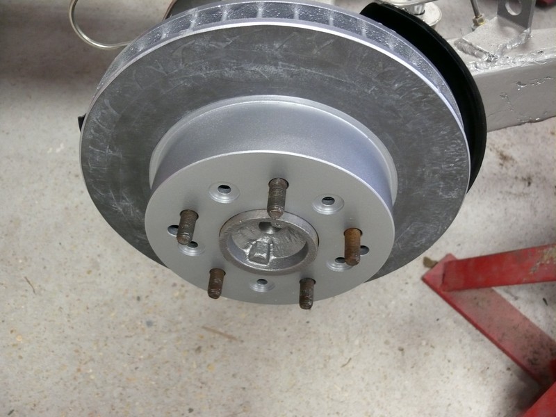 Vehicle brake rotor and hub assembly with lug studs.