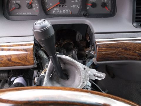 1999 Mercury Grand Marquis - Interior view of a car's dashboard with the steering column and gear shifter visible. The instrument cluster shows gauges for volts, fuel,…