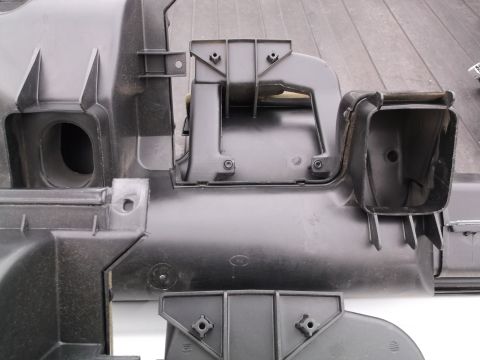 1999 Mercury Grand Marquis - This is a close-up, overhead view of black plastic automotive interior components, likely part of a ventilation system. The parts feature v…