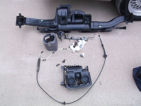 1999 Mercury Grand Marquis - A disassembled car interior HVAC ducting system and related components are laid out on a concrete surface. The parts include a large black…