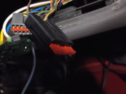 1999 Mercury Grand Marquis - A close-up view shows a black electrical connector with red terminals plugged into a gray connector with visible red terminals. Various wir…