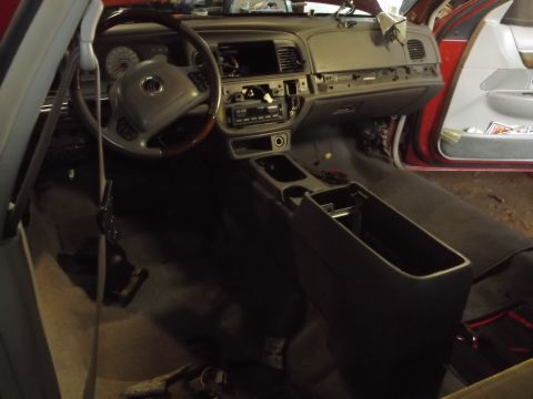 1999 Mercury Grand Marquis - The interior of a Mercury Grand Marquis is shown with the dashboard and center console partially disassembled. The steering wheel, radio, a…