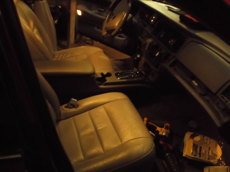 Interior of a car with tan leather seats and dashboard.