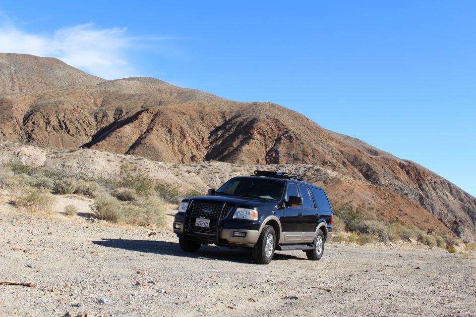 Black Ford Expedition SUV parked in a desert landscape.
