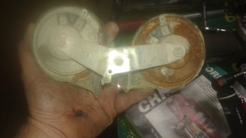 1996 Ford Bronco - A pair of old, rusty horns are held in a hand, with some text visible in the background.